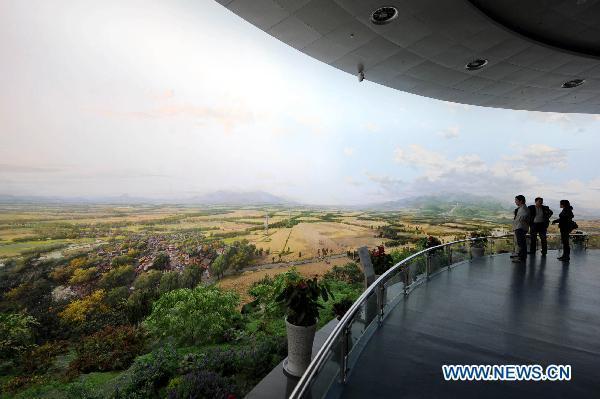 Visitors view the panoramic painting entitled Splendid Central Plains in Zhengzhou, central China's Henan Province, April 26, 2011. 