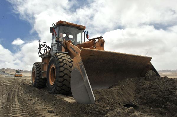 A bulldozer works on the Xinzang Road in construction in Ritu County of Tibet Autonomous Region, on May 2, 2011.