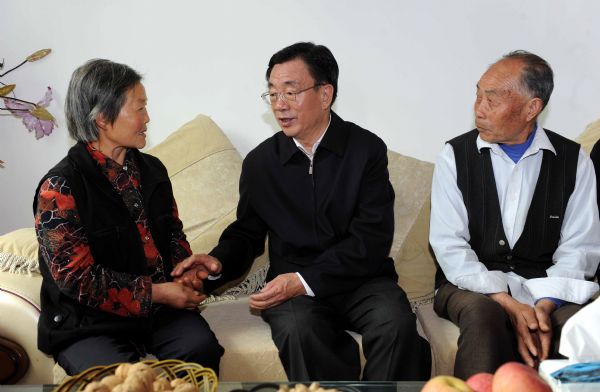 He Guoqiang (C), a member of the Standing Committee of the Political Bureau of the Communist Party of China (CPC) Central Committee and secretary of the CPC Central Commission for Discipline Inspection, visits a family in Qinglong Village, Lexing Town of Anxian County, southwest China's Sichuan Province, May 3, 2011.