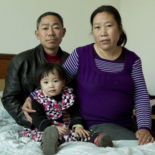 Feng Mingqiu, 42, and her husband, Dong Yuanjun, 45, pose with their 2-year-old daughter in Mianzhu, Sichuan Province, April 18, 2011.