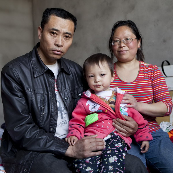 Chen Xiaohua, 43, and her husband, Deng Guoyun, 44, pose with their 2-year-old daughter in Mianzhu, Sichuan Province, April 18, 2011.