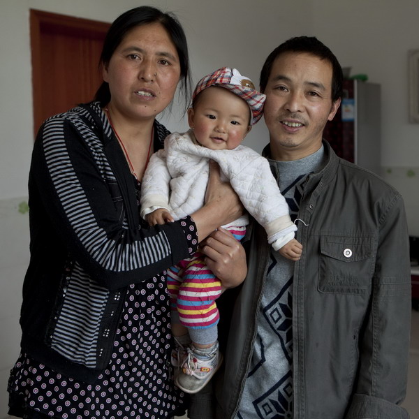 Li Xingqiong, 43, and her husband, Yuan Taixing, 44, pose with their 1-year-old son in Mianzhu, Sichuan Province, April 18, 2011. 