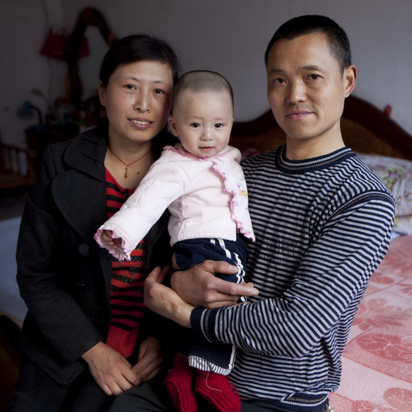 Feng Mingqiu, 42, and her husband, Dong Yuanjun, pose with their 1-year-old son in Mianzhu, Sichuan Province, April 15, 2011.