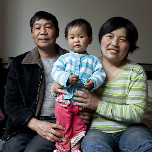 Wang Guiju, 41, and her husband Xiao Yuanyu, 43, pose with their 1-year-old daughter in Mianzhu, Sichuan Province, April 18, 2011. 