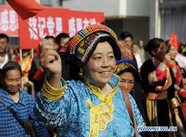 A woman parades in traditional costumes in Lixian County, southwest China's Sichuan Province, May 8, 2011. 