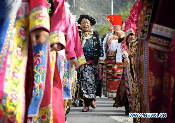 A woman parades in traditional costumes in Lixian County, southwest China's Sichuan Province, May 8, 2011. 