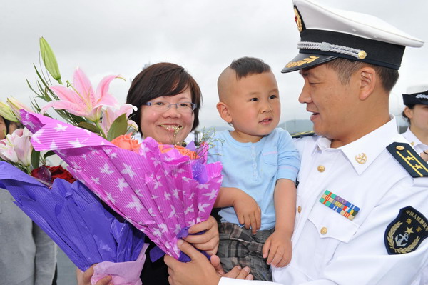 Li Guohui hugs his three-year-old son during a welcome ceremony for the return of Chinese Navy Seventh Escort Task Force in Zhoushan, east China&apos;s Zhejiang Province, May 9, 2011. 