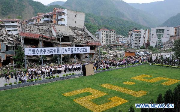 Photo taken on May 12, 2011 shows a memorial ceremony for fellow countrymen lost in the 2008 Wenchuan earthquake in Beichuan, southwest China&apos;s Sichuan Province.