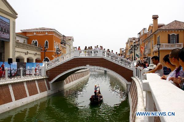 People shop at Tianjin Florence Town Outlets in Wuqing District of north China's Tianjin Municipality, June 9, 2011. 