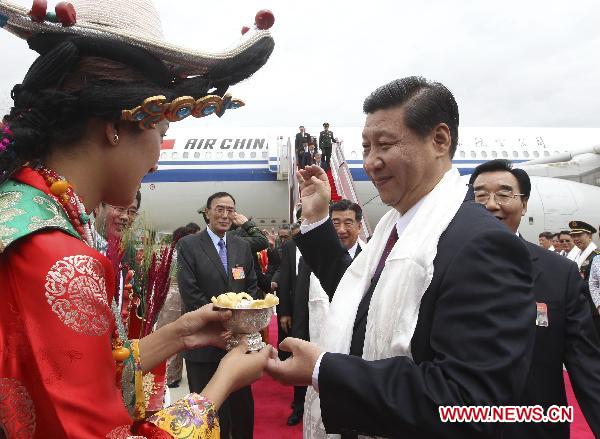 Chinese Vice President Xi Jinping (R) is welcomed upon his arrival in Lhasa, capital of southwest China's Tibet Autonomous Region, on July 17, 2011. 