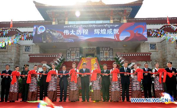 Chinese Vice President Xi Jinping (C) attends the ribbon-cutting ceremony for the exhibition of achievements made in the 60 years since Tibet's peaceful liberation, in Lhasa, capital of southwest China's Tibet Autonomous Region, July 18, 2011.