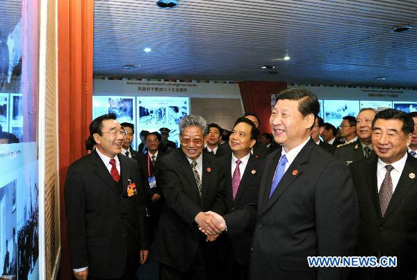 Chinese Vice President Xi Jinping (R Front) visits the exhibition of achievements made in the 60 years since Tibet's peaceful liberation, in Lhasa, capital of southwest China's Tibet Autonomous Region, July 18, 2011.