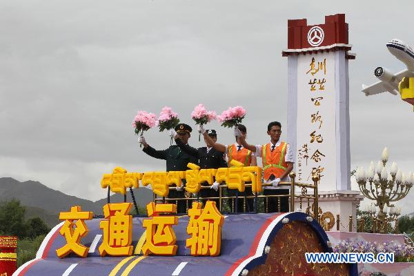 People take part in a grand celebration parade marking the 60th anniversary of Tibet's peaceful liberation in Lhasa, capital of southwest China's Tibet Autonomous Region, on July 19, 2011.