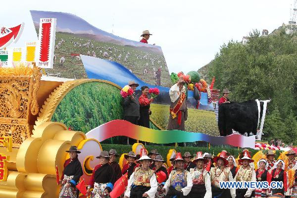 People take part in a grand celebration parade marking the 60th anniversary of Tibet&apos;s peaceful liberation in Lhasa, capital of southwest China&apos;s Tibet Autonomous Region, on July 19, 2011.