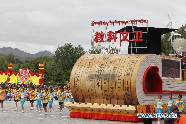 People take part in a grand celebration parade marking the 60th anniversary of Tibet&apos;s peaceful liberation in Lhasa, capital of southwest China&apos;s Tibet Autonomous Region, on July 19, 2011.