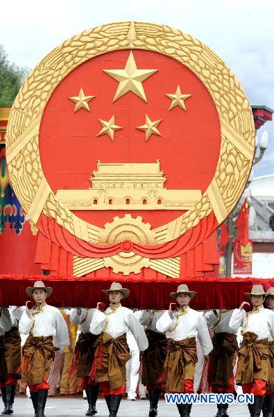 People take part in a grand celebration parade marking the 60th anniversary of Tibet&apos;s peaceful liberation in Lhasa, capital of southwest China&apos;s Tibet Autonomous Region, on July 19, 2011.