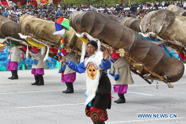 People take part in a grand celebration parade marking the 60th anniversary of Tibet's peaceful liberation in Lhasa, capital of southwest China's Tibet Autonomous Region, on July 19, 2011.