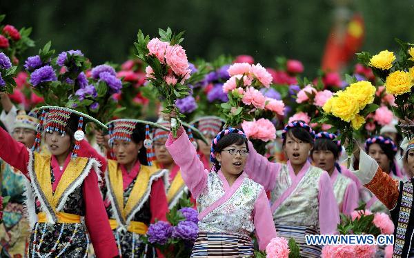 People take part in a grand celebration parade marking the 60th anniversary of Tibet's peaceful liberation in Lhasa, capital of southwest China's Tibet Autonomous Region, on July 19, 2011.