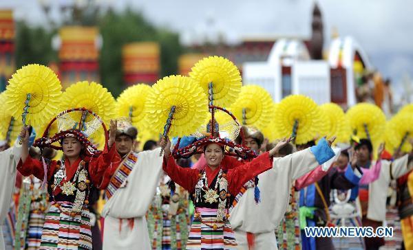 People take part in a grand celebration parade marking the 60th anniversary of Tibet's peaceful liberation in Lhasa, capital of southwest China's Tibet Autonomous Region, on July 19, 2011.