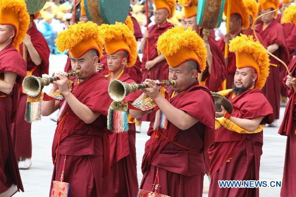 People take part in a grand celebration parade marking the 60th anniversary of Tibet's peaceful liberation in Lhasa, capital of southwest China's Tibet Autonomous Region, on July 19, 2011.