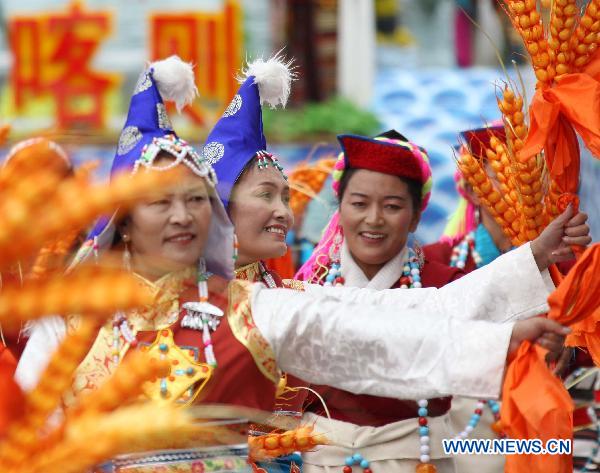 People take part in a grand celebration parade marking the 60th anniversary of Tibet's peaceful liberation in Lhasa, capital of southwest China's Tibet Autonomous Region, on July 19, 2011. 