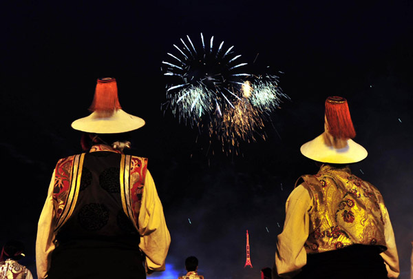 Tibetans watch fireworks light up the sky at Potala Palace Square in Lhasa to celebrate the 60th anniversary of the peaceful liberation of Tibet on July 19, 2011.
