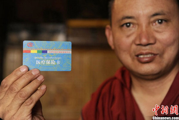 A 67-year old monk is showing his medical service card in the Sera Monastery, one of the three major monasteries of the Gelug Sect in Lhasa, southwest China&apos;s Tibet Autonomous Region. 
