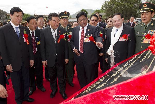 Chinese Vice Premier Hui Liangyu (2nd L, Front) attends the unveiling ceremony of a plaque that marks Kesum Village of Nedong County as 'Pioneer of Democratic Reforms in Tibet' during a visit to Shannan Prefecture, southwest China's Tibet Autonomous Region, July 21, 2011.