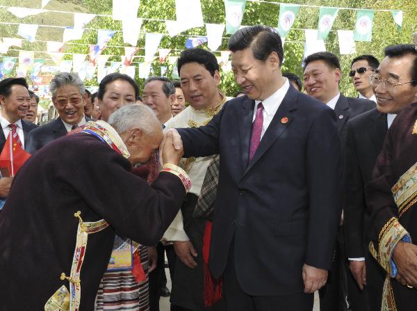 Chinese Vice President Xi Jinping (R, Front) is greeted by a man of Tibetan ethnic group during a visit to the village of Bagyi in Nyingchi Prefecture, southwest China's Tibet Autonomous Region, July 21, 2011.