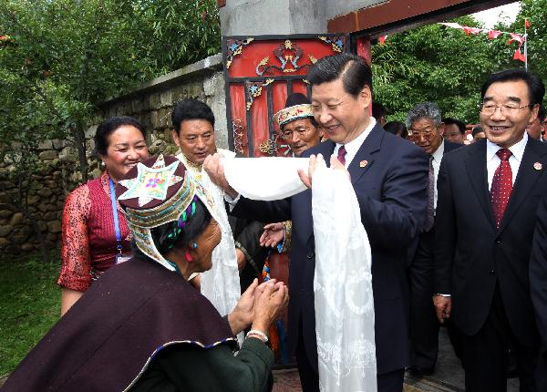 Chinese Vice President Xi Jinping (C, Front) receives a traditional white scarf known as 'hada' during a visit to the village of Bagyi in Nyingchi Prefecture, southwest China's Tibet Autonomous Region, July 21, 2011. 