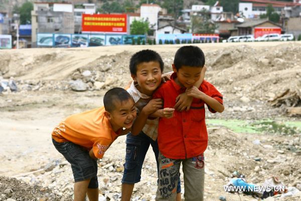Boys are seen grinning in Zhouqu County of Gannan Tibetan Autonomous Prefecture, northwest China's Gansu Province, Aug. 2, 2011. 