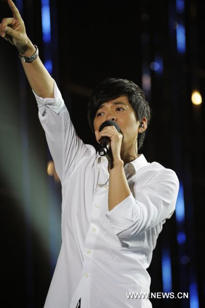 Chinese singer Li Jian performs during the World University Student Beach Concert in Shenzhen, a city of south China's Guangdong Province, Aug. 10, 2011. 
