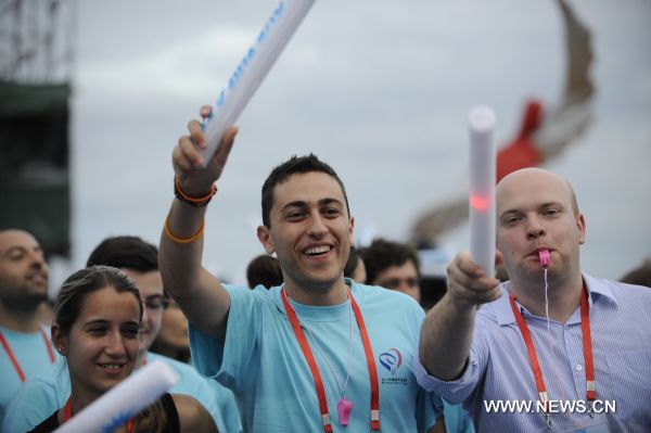 Foreign young people react during the World University Student Beach Concert in Shenzhen, a city of south China's Guangdong Province, Aug. 10, 2011. 