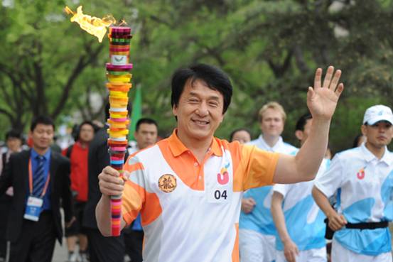 Torchbearer Jacky Chan runs with the torch during the torch relay for the 26th Summer Universiade at Shenzhen, south China&apos;s Guangdong Province, on May 4, 2011.
