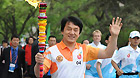 Torchbearer Jacky Chan runs with the torch during the torch relay for the 26th Summer Universiade at Shenzhen, south China's Guangdong Province, on May 4, 2011.