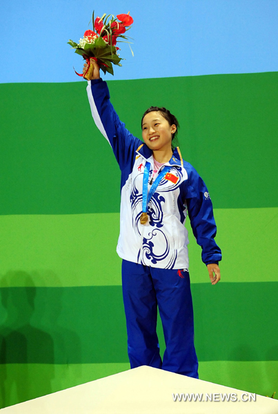 Xiao Hongyu of China poses at the awarding ceremony of the women's 48kg weightlifting competition at the 26th Summer Universiade in Shenzhen, a city of south China's Guangdong Province, Aug. 13, 2011. 