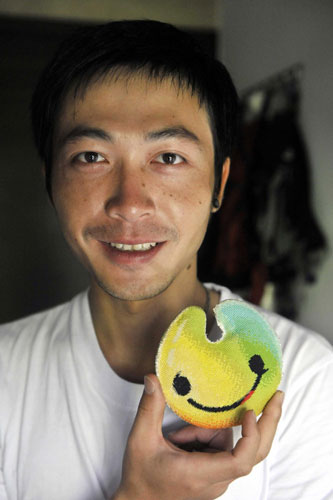 Zhou Ziqian shows UU, the mascot for the Shenzhen Summer Universiade, in Shenzhen, Guangdong Province, on August 14, 2011.