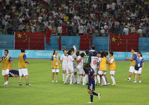 Chinese players celebrate after a 2-1 victory over Japan in Shenzhen, south China's Guangdong province, on Sunday, August 21, 2011. 
