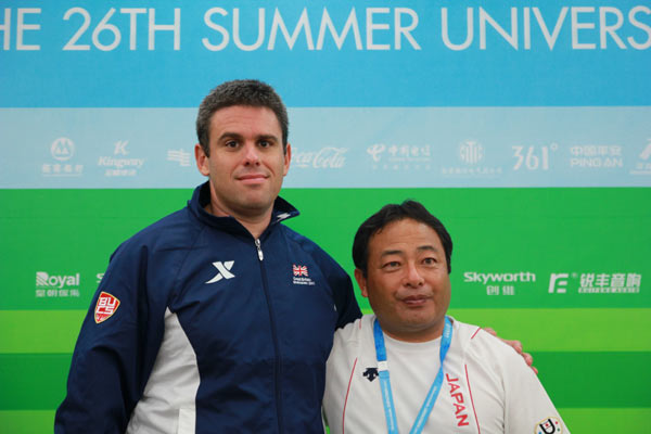 Britain's head coach Ellis James (L) and Japan's head coach Nakano Yuji (R) pose for a photo during a news conference after the men's soccer finals at the 26th Summer Universiade in Shenzhen, Aug 22, 2011. 