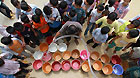 Water transported by a water wagon is allocated to students and teachers at Gengsha School in Fengshan County, south China's Guangxi Zhuang Autonomous Region, Sept 7, 2011.