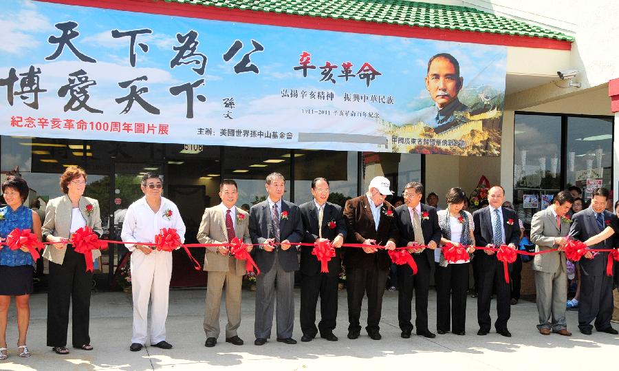 Guests cut the ribbon for the opening of a photo exhibition marking the 100th anniversary of the Chinese Xinhai (1911) Revolution in Orlando, the United States, Sept. 17, 2011.