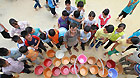 Students at Gengsha School in Fengshan County of Hechi City, in Guangxi Zhuang Autonomous Region, wait for drinking water on Sept 19, 2011.