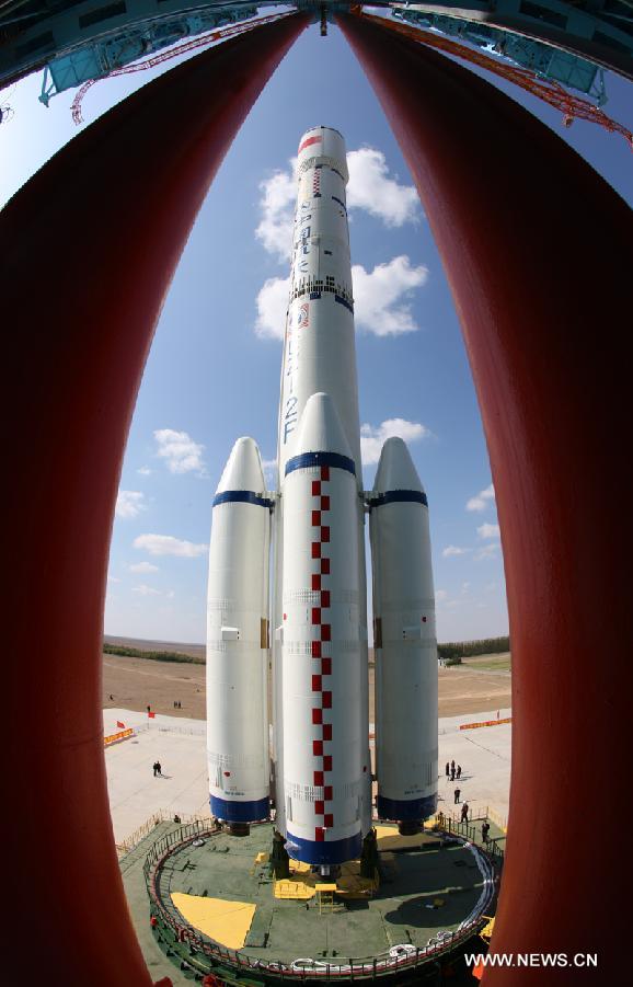 A Long March 2F carrier rocket loaded with 'Tiangong-1', China's unmanned space module, is moved to the launch pad at the Jiuquan Satellite Launch Center in northwest China's Gansu Province, Sept. 9, 2011. 