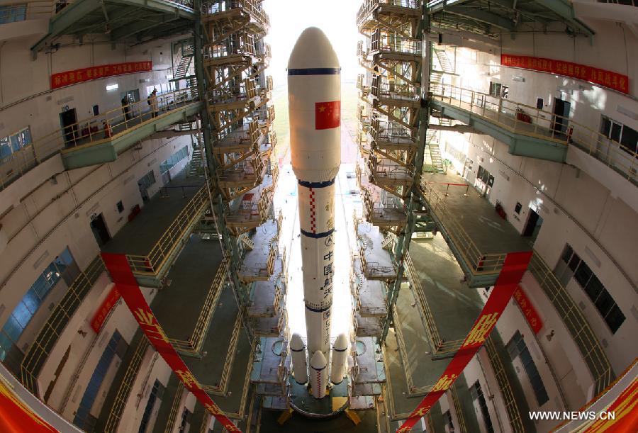 A Long March 2F carrier rocket loaded with 'Tiangong-1', China's unmanned space module, is moved to the launch pad at the Jiuquan Satellite Launch Center in northwest China's Gansu Province, Sept. 9, 2011. 