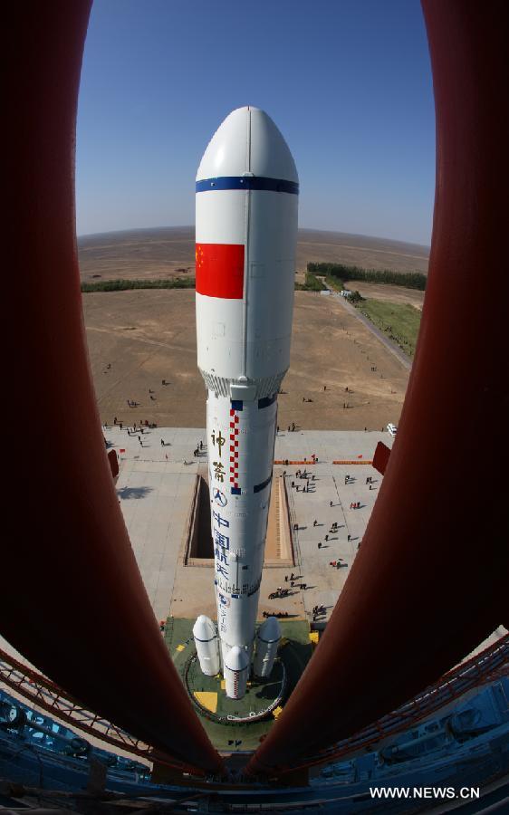 A Long March 2F carrier rocket loaded with 'Tiangong-1', China's unmanned space module, is moved to the launch pad at the Jiuquan Satellite Launch Center in northwest China's Gansu Province, Sept. 9, 2011. 