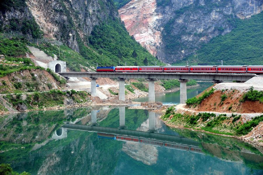 File photo taken on May 8, 2009 shows a passenger train passes through 109 tunnel of the Baoji-Chengdu Railway in northwest China&apos;s Shaanxi Province.