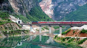 File photo taken on May 8, 2009 shows a passenger train passes through 109 tunnel of the Baoji-Chengdu Railway in northwest China's Shaanxi Province.