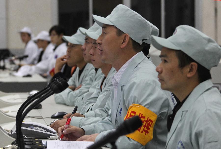Technicians are seen during a joint test at the Jiuquan Satellite Launch Center in northwest China&apos;s Gansu Province, Sept. 28, 2011. 