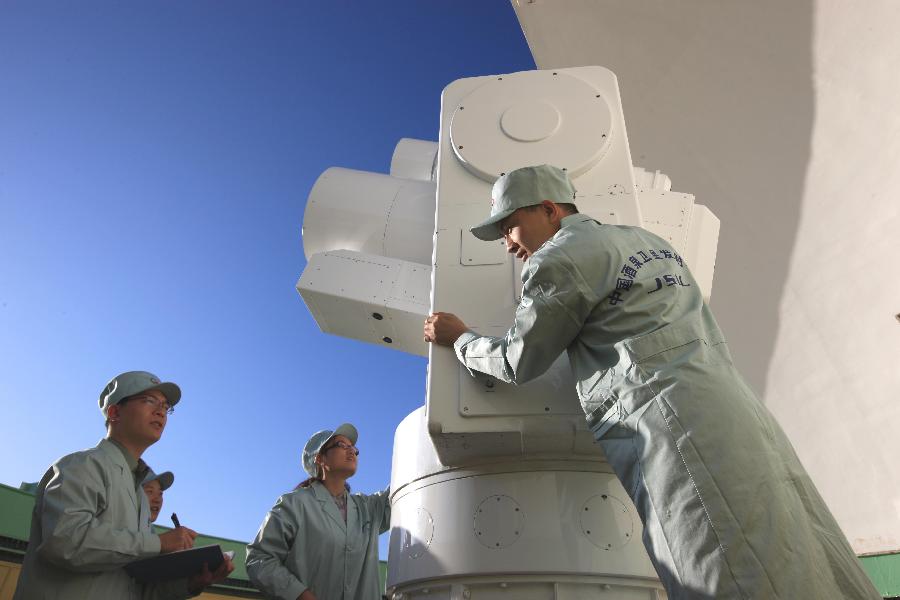 Technicians check equipment at the Jiuquan Satellite Launch Center in northwest China&apos;s Gansu Province, Sept. 27, 2011. 