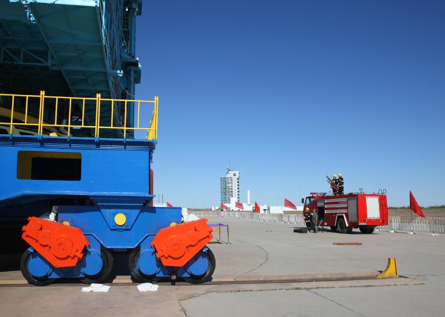 Fire fighters are on duty beside a launch pad at the Jiuquan Satellite Launch Center in northwest China&apos;s Gansu Province, Sept. 28, 2011.